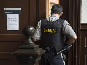 A sheriff's deputy stands outside youth court at provincial court in Halifax on Thursday, November 13, 2014. A young man who pleaded guilty in a prominent child pornography case in Halifax has been given a conditional discharge and will be registered in the national DNA databank. THE CANADIAN PRESS/Andrew Vaughan