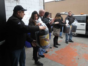Volunteers unload sleeping bags in memory of the late, Matthew Joseph Rawlings, at the Street Help Homeless Centre of Windsor on November 25, 2014. (JASON KRYK/The Windsor Star)