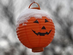 A Halloween decoration is capped with snow Monday, Nov. 17, 2014, in Windsor, ON. (DAN JANISSE/The Windsor Star)