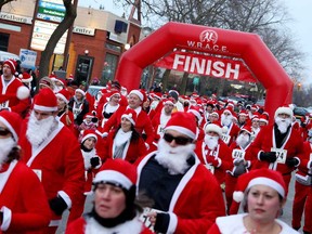 The Santas are set free at the start of the Super Santa run/walk  in downtown Amherstburg, Nov. 15, 2014. Proceeds of the event go to the Essex Region Conservation Foundation. (RICK DAWES/The Windsor Star)