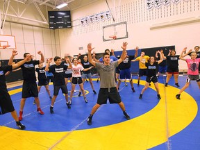 Students at Tecumseh Vista Academy do jumping jacks in the school's gymnasium on Nov. 27, 2014. (Jason Kryk / The Windsor Star)