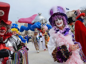 Members of the Distinguished Clown Corps walk in the Thanksgiving Parade, Thursday, Nov. 27, 2014, in Detroit. (AP Photo/Detroit Free Press, Ryan Garza)