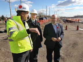 Ontario Minister of Transportation Steven Del Duca visited the Hon. Herb Gray Parkway project on Friday, Nov. 7, 2014, in Windsor, ON. to check on the progress of the work. Michael Hatchell (L), project director for the Parkway, Garfield Dales (C), manager, project delivery at Ontario Ministry of Transportation speak with Del Duca (R) during the event. (DAN JANISSE/The Windsor Star)