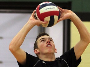 Cayman Gagnon of E.J. Lajeunesse sets against Academie Ste. Cecile in senior boys volleyball action November 5,  2014.  (NICK BRANCACCIO/The Windsor Star)
