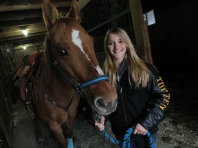 Julia Adams, 14, is photographed with her horse Bones at her home near Harrow recently. Last month, Adams placed fifth in a North American riding competition in Columbus, Ohio. (TYLER BROWNBRIDGE / The Windsor Star)