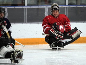 Canadian Para-Olympian goalie Corbin Watson has some fun with other sledge hockey players during open practice in Amherstburg recently. (NICK BRANCACCIO / The Windsor Star)