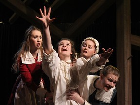 Actors Alice Lundy, left, Arielle Zamora, Erin Burley and Rebecca Young rehearse a scene from the University Players production of Arthur Miller’s The Crucible, at Essex Hall. (TYLER BROWNBRIDGE / The Windsor Star)
