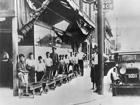 Underage delivery runners line up outside of the Brewers Warehouse on Wyandotte with their little red wagons, waiting to pick up another load of beer.