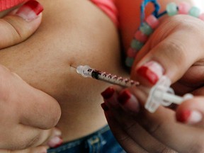 A 19-year-old diagnosed with diabetes gives herself an injection of insulin at her home in the Los Angeles suburb of Commerce, Calif. (Reed Saxon / Associated Press files)