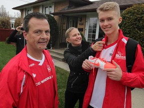 - Local socceer player Phillip Jurkowski, right, says his goodbyes to parents Marta, shown and Jacek Jurkowski, behind, as Phillip and Coach Paul Scott, left, head to the International Children's Games in Lake MacQuarie, Austrailia Tuesday December 2, 2014. (NICK BRANCACCIO/The Windsor Star)