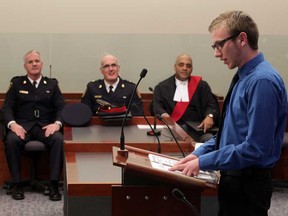 Police Ethnic and Cultural Exchange (PEACE) youth leadership program member Jon Barron, right,  addresses the graduating class in front of Windsor Police Deputy Chief Vince Power, left, Chief Al Frederick and Justice Lloyd Dean at Ontario Court of Justice December 4, 2014.  (NICK BRANCACCIO/The Windsor Star)