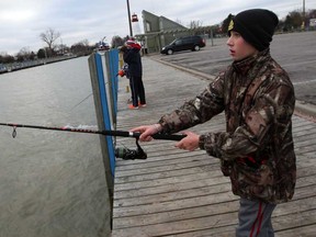 Young fishermen Max Marotte, right, Dylan Cadarian and Matty Dimoff, back left, fish off the dock at Lakeview Park Marina  Wednesday December 9, 2014.  (NICK BRANCACCIO/The Windsor Star)