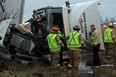 Lakeshore firefighters, OPP and Essex-Wiindsor EMS paramedics work to rescue a 49-year-old truck driver following a crash on east bound Hwy. 401 near Lakeshore Road 106, Wednesday December 9, 2014. (NICK BRANCACCIO/The Windsor Star)