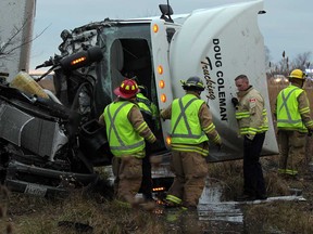 Lakeshore firefighters, OPP and Essex-Wiindsor EMS paramedics work to rescue a 49-year-old truck driver following a crash on east bound Hwy. 401 near Lakeshore Road 106, Wednesday December 9, 2014. (NICK BRANCACCIO/The Windsor Star)