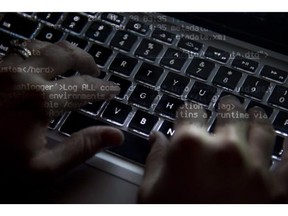 A woman uses her computer key board to type while surfing the internet in North Vancovuer, B.C., on Wednesday, December, 19, 2012. The federal privacy watchdog is trying to help the Conservative government find a compromise in its contentious bid to bolster Internet surveillance powers. THE CANADIAN PRESS/Jonathan Hayward