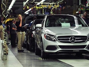 In this June 18, 2014 file photo, workers produce C-Class sedans at the Mercedes plant near Tuscaloosa, Ala. The National Labor Relations Board on Wednesday, Nov. 26, 2014 upheld a ruling that Mercedes violated federal labor laws by stopping United Auto Workers union supporters from handing out literature inside its Alabama plant. (AP Photo/AL.com, Tamika Moore, File)