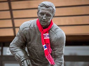 A Montreal Canadiens scarf is wrapped around a statue of former Canadiens legend Jean Beliveau in front of the Jean Beliveau Arena Wednesday, December 3, 2014 in Longueuil, Que. Beliveau died at the age of 83.