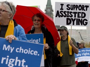 Supporters rally outside the Supreme Court of Canada on the first day of hearings into whether Canadians have the right to seek help to end their own lives Wednesday October 15, 2014 in Ottawa. THE CANADIAN PRESS/Adrian Wyld