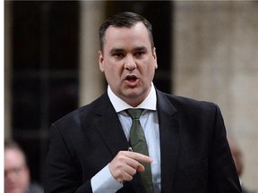 Industry Minister James Moore responds to a question during question period in the House of Commons on Parliament Hill in Ottawa on Monday, April 28, 2014. The federal government offered a new source of hope for Canada's small wireless companies on Monday, giving them a shot at high-quality wireless spectrum earlier than expected and limiting how much can be purchased by the largest players.
Photograph by: Sean Kilpatrick/Postmedia News)