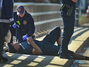 A Charlotte firefighter tends to Carolina Panthers NFL football quarterback Cam Newton following a two-vehicle crash not far from the team's stadium in Charlotte, N.C., Tuesday, Dec. 9, 2014. (AP Photo/The Charlotte Observer, Todd Sumlin) MAGS OUT; TV OUT; NEWSPAPER INTERNET ONLY