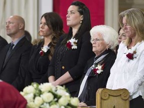 Family members including (right) daughter Helene, widow Elise (second right) and granddaughters Mylene amd Magalie attend the funeral for former Montreal Canadiens captain Jean Beliveau at Mary Queen of the World Cathedral in Montreal, Wednesday, Dec.10, 2014. THE CANADIAN PRESS/Paul Chiasson