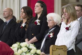 Family members including (right) daughter Helene, widow Elise (second right) and granddaughters Mylene amd Magalie attend the funeral for former Montreal Canadiens captain Jean Beliveau at Mary Queen of the World Cathedral in Montreal, Wednesday, Dec.10, 2014. THE CANADIAN PRESS/Paul Chiasson
