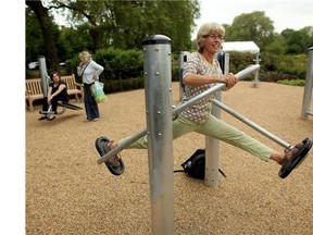 Tessa Morrison (R) is watched by Katherine Thompson (L) and Jill Jones (Second Left) as she exercises in London's first purpose built 'Senior Playground' in Hyde Park on May 19, 2010 in London, England. The playground, which cost 50,000 GBP, features six machines: a cross-trainer, sit-up bench, body-flexer, free runner, flex wheel and an exercise bike.(Oli Scarff/Postmedia News)