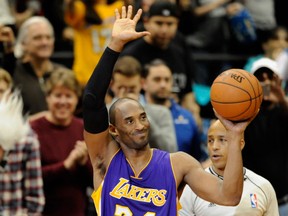 Kobe Bryant #24 of the Los Angeles Lakers waves to the crowd after passing Michael Jordan on the all-time scoring list with a free throw in the second quarter of the game on December 14, 2014 at Target Center in Minneapolis, Minnesota.