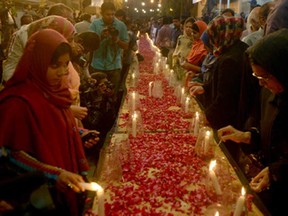 Pakistani female activists of Muttahida Qaumi Movement (MQM) light candles for the victims of an attack by Taliban gunmen on a school in Peshawar, in Karachi on December 16, 2014. Taliban insurgents killed at least 141 people, almost all of them children, after storming an army-run school in Pakistan's bloodiest ever terror attack. AFP PHOTO / Rizwan TABASSUMRIZWAN TABASSUM/AFP/Getty Images