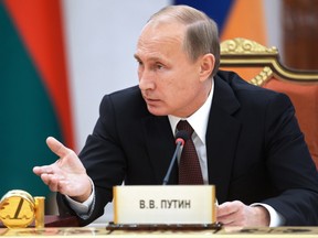 Russian President Vladimir Putin speaks to the leaders of ex-Soviet states during a meeting in Minsk, Belarus, Friday, Oct. 10, 2014. Putin lashed out at the European Union for not considering it necessary to discuss the risks of political and economic integration with post-Soviet countries. Ukraines decision to sign an association agreement with the European Union in September provoked complaints from the Kremlin that the deal would hurt Russias economy. (AP Photo/RIA-Novosti, Alexei Nikolsky, Presidential Press Service)