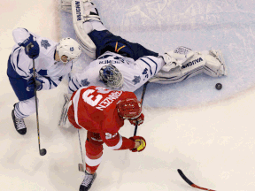 Leafs goalie James Reimer, back, makes a save on Detroit's Johan Franzen during the third period Wednesday at Joe Louis Arena. (AP Photo/Carlos Osorio)