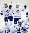 Toronto’s Tyler Bozak, left, and James van Riemsdyk approach Phil Kessel, bottom right, after Kessel’s tying goal in the third period. (AP Photo/Carlos Osorio)