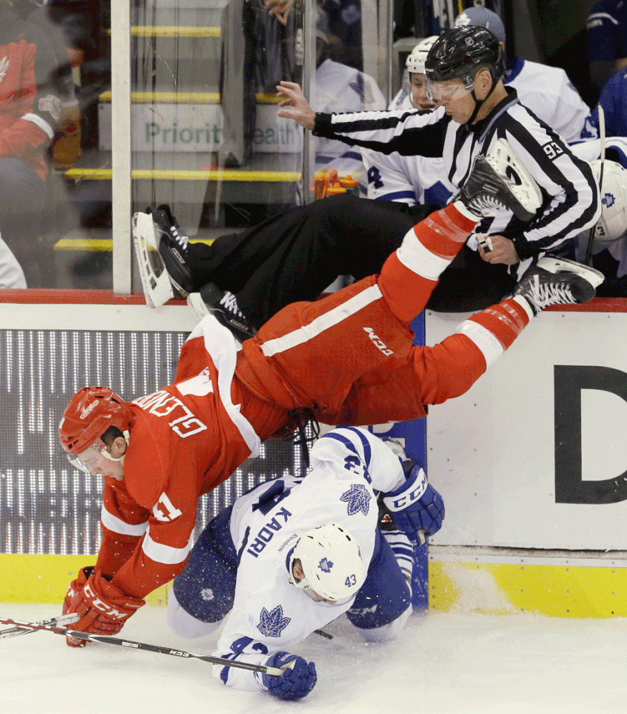 Toronto Maple Leafs center Mike Santorelli (25) shoots the puck past Detroit Red Wings goalie Jimmy Howard (35) for the winning goal in the shootout period of an NHL hockey game in Detroit, Wednesday, Dec. 10, 2014. The Maple Leafs defeated the Red Wings, 2-1. (AP Photo/Carlos Osorio)