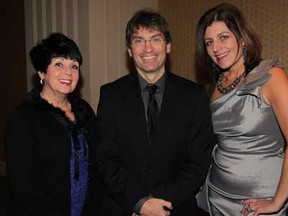 Barb Malmberg, left, Matt Marchand and Marianne Burke pose during Windsor-Essex Regional Chamber of Commerce 12th Annual Multiple Business Holiday Party 2014 at Augustus Ballroom Caesars Windsor Friday December 12, 2014. Over 350 people from 26 local companies joined to celebrate the holiday season and visit with Santa Claus. (NICK BRANCACCIO/The Windsor Star)