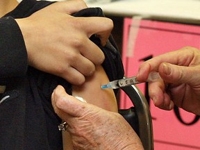 A student receives an immunization shot. (Windsor Star files)