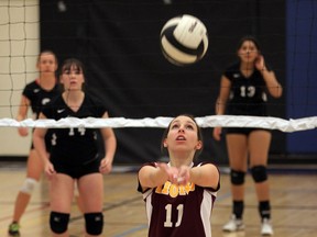 Leamington's Chelsey Malott, centre, bumps the volleyball to a teammate against Tecumseh Vista Academy Monday. (NICK BRANCACCIO/The Windsor Star)