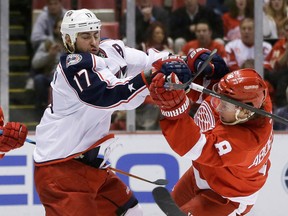 Columbus' Brandon Dubinsky, left, checks Detroit's Justin Abdelkader during the second period Tuesday in Detroit. (AP Photo/Carlos Osorio)