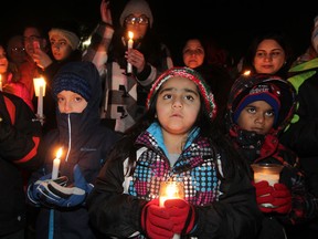 Local Pakistani community, friends and supporters lit candles at Dieppe Park during a vigil following the horrible school massacre just three days ago in Pakistan.   (NICK BRANCACCIO/The Windsor Star)