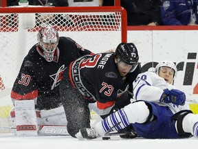 Windsor's Brett Bellemore, centre, and Carolina goalie Cam Ward, left, defend the goal against Toronto's David Booth Thursday in Raleigh, N.C. (AP Photo/Gerry Broome)