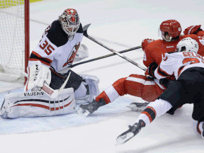 Detroit's Darren Helm, centre, scores a goal against New Jersey Devils goalie Cory Schneider during the third period at Joe Louis Arena Wednesday. (AP Photo/Carlos Osorio)