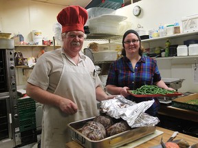 Doug Romanek and Gillian Romanek prepare food at Nana's Bakery for a 6pm dinner at the Windsor Youth Centre. (JASON KRYK/The Windsor Star)