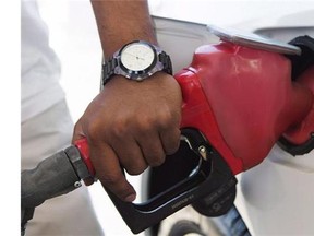 A person pumps fuel in Toronto after gasoline prices rose overnight on Wednesday, September 12, 2012. From Alberta oilfields to Bay Street boardrooms to the corner gas station, the precipitous drop in the price of crude oil is expected to have far-reaching impacts across the country heading into 2015, making it The Canadian Press Business News Story of the Year. THE CANADIAN PRESS/Michelle Siu