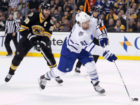 Boston's Zdeno Chara, left, hooks Toronto's Phil Kessel on a breakaway during the first period in Boston, Wednesday. (AP Photo/Michael Dwyer)