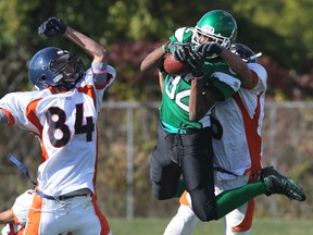 Herman receiver Devon Woods, centre, fights to keep possession of the football while scoring a touchdown against the Sandwich Sabres in LaSalle. (JASON KRYK/The Windsor Star)