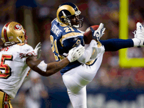 Windsor's Oshiomogho Atogwe, right, intercepts a pass intended for Vernon Davis of the San Francisco 49ers at the Edward Jones Dome in 2008 in St. Louis. (Photo by Dilip Vishwanat/Getty Images)