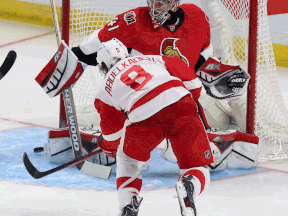 Ottawa goaltender Craig Anderson, right, makes a save on Detroit's Justin Abdelkader during the first period in Ottawa Saturday. (THE CANADIAN PRESS/Fred Chartrand)