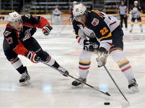 Windsor's Eric Diodati, left, checks Barrie's Andreas Athanasiou at the Molson Centre. (Mark Wanzel photo)