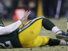 Detroit Lions defensive tackle Ndamukong Suh, right, steps on the leg of Green Bay Packers quarterback Aaron Rodgers during the fourth quarter Sunday in Green Bay. (AP Photo/Milwaukee Journal-Sentinel, Mark Hoffman)
