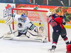 Spits forward Cristiano DiGiacinto, right, scores a goal on Plymouth goalie Zack Bowman in the second period Tuesday in Plymouth. (RENA LAVERTY/Plymouth Whalers)