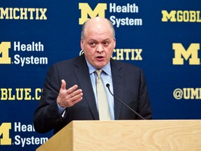 Michigan interim athletic director Jim Hackett announces the immediate dismissal of head coach Brady Hoke during a press conference in Ann Arbor Tuesday. (AP Photo/Tony Ding)